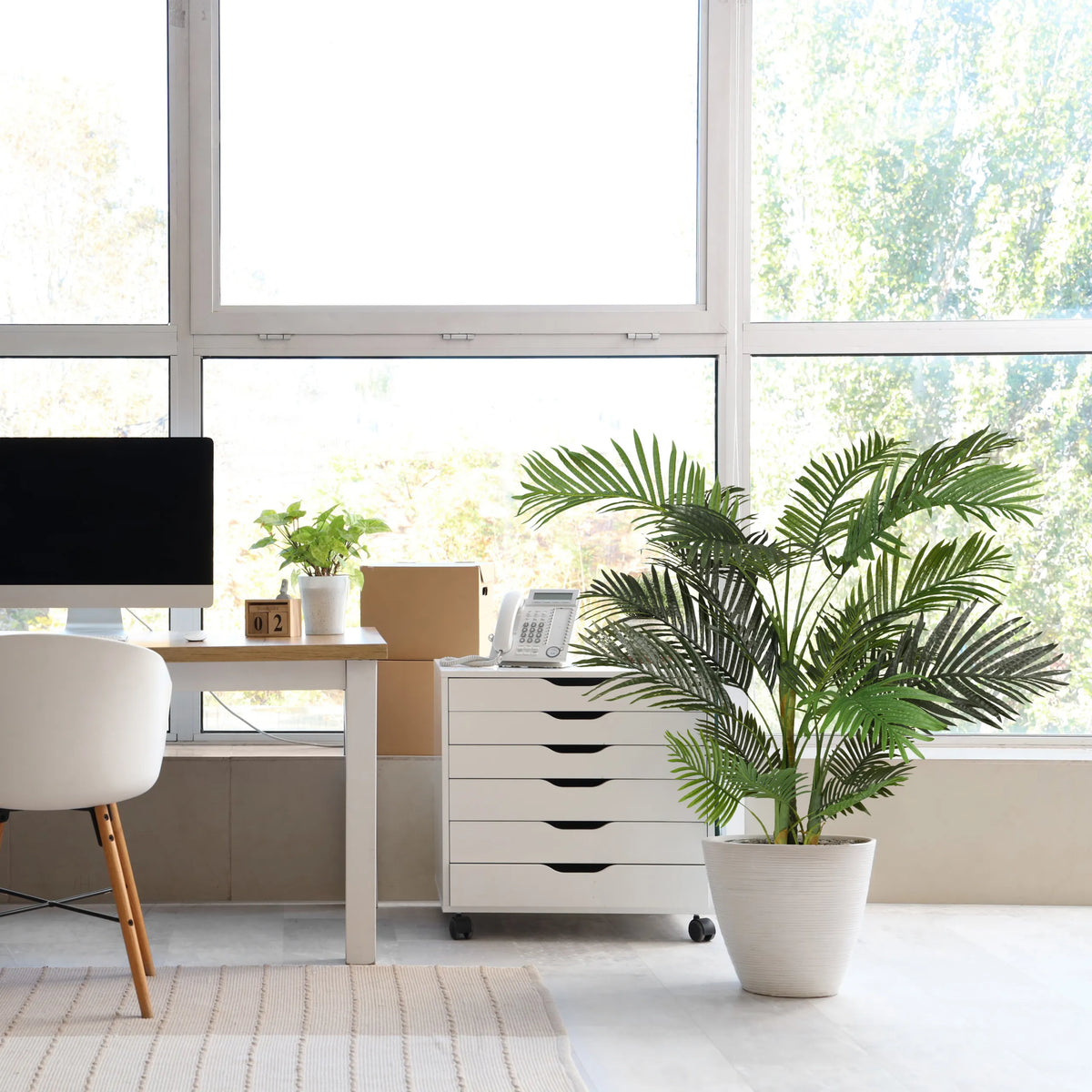 Green artificial plant ARECA II in a white pot next to a white mobile pedestal by hjh OFFICE