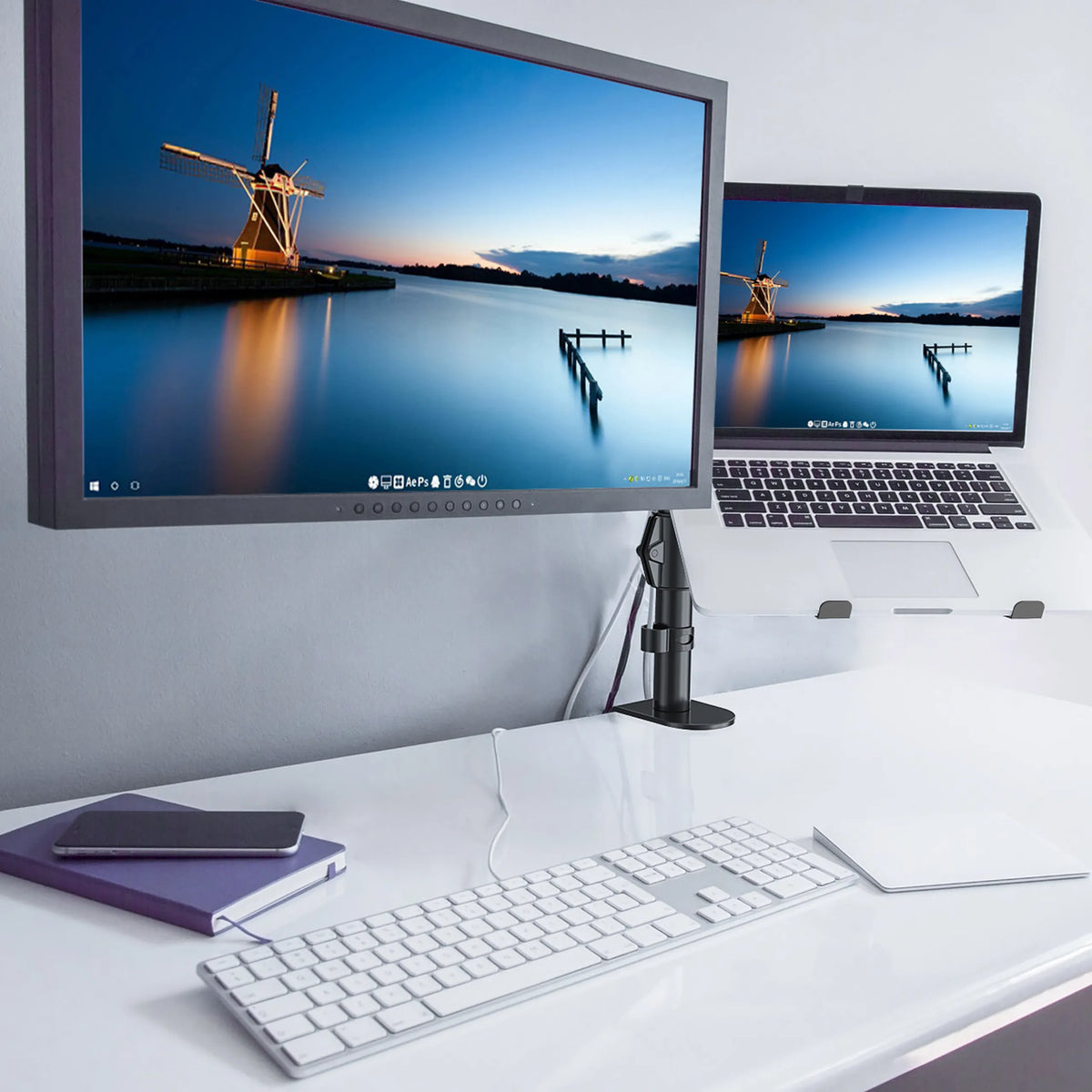Black VM-MH2 monitor mount with a screen attached on a white desk by hjh OFFICE