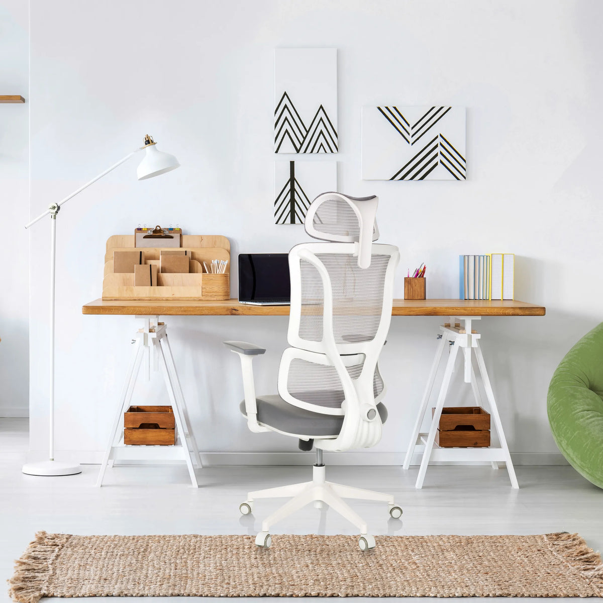 Professional Office Chair ERGOMY W in grey with a white frame and mesh backrest at a desk by MyBuero