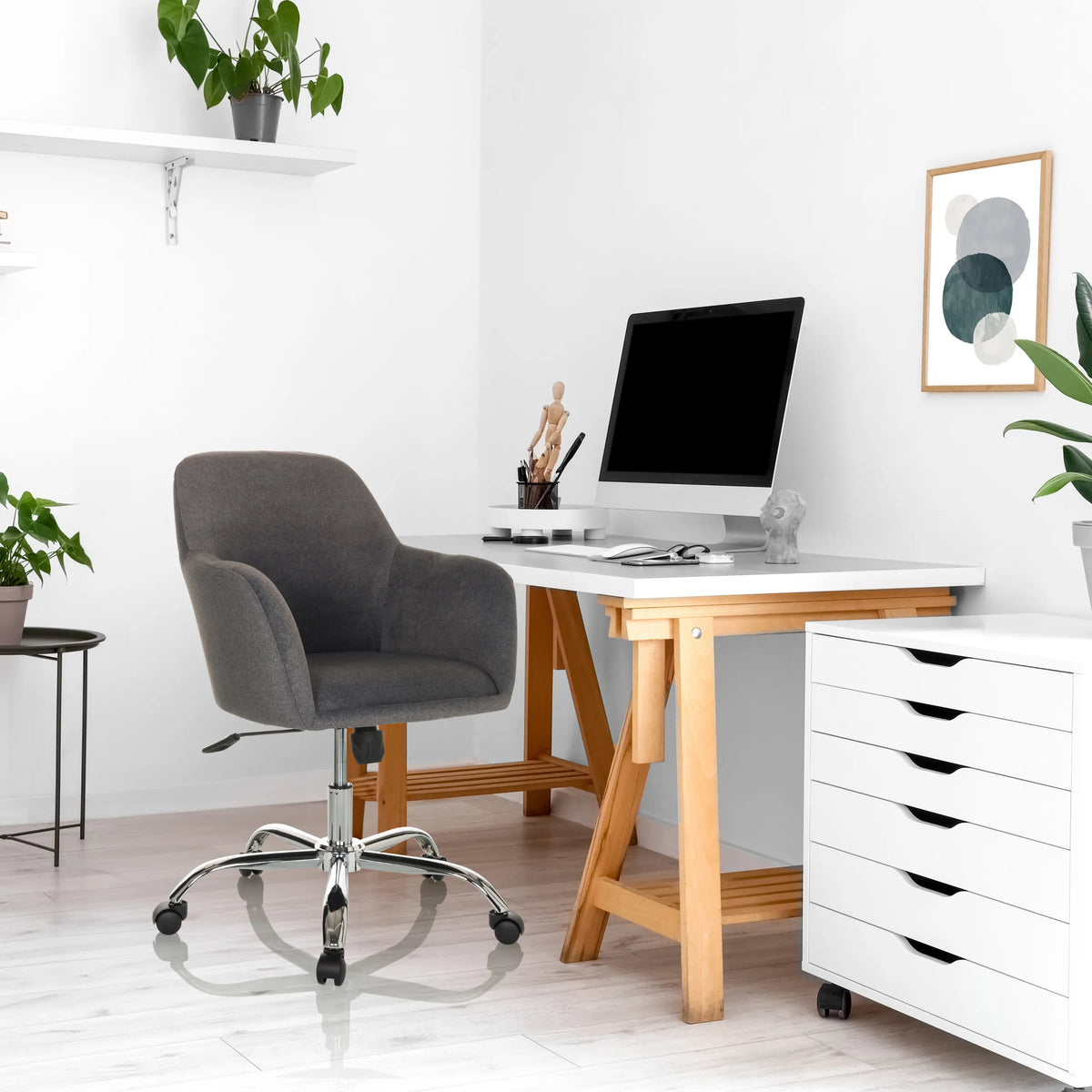 Dark grey Home Office Chair SOLAO 300 with star base and castors in front of a desk by hjh OFFICE