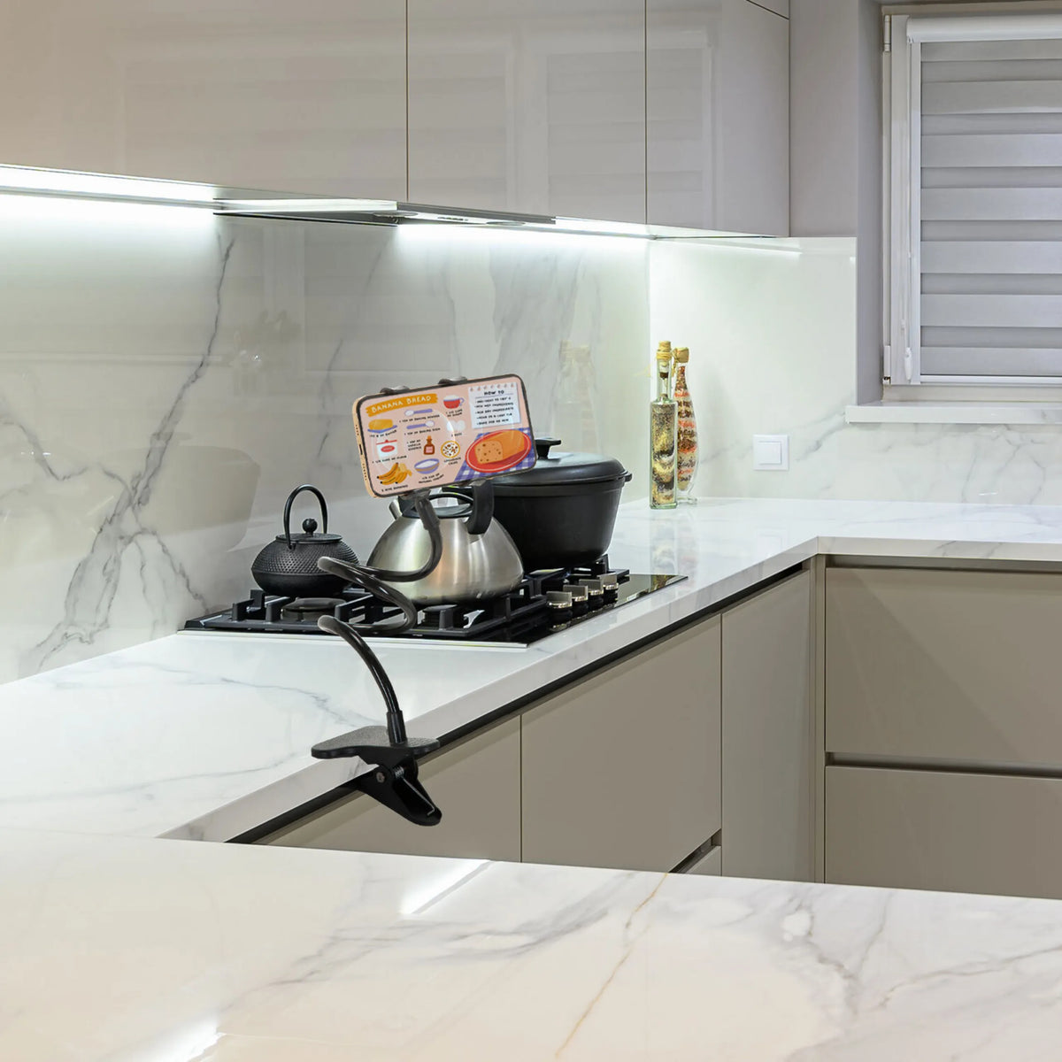 Black Mobile phone & tablet holder FLEXMOBI on a kitchen worktop by hjh OFFICE