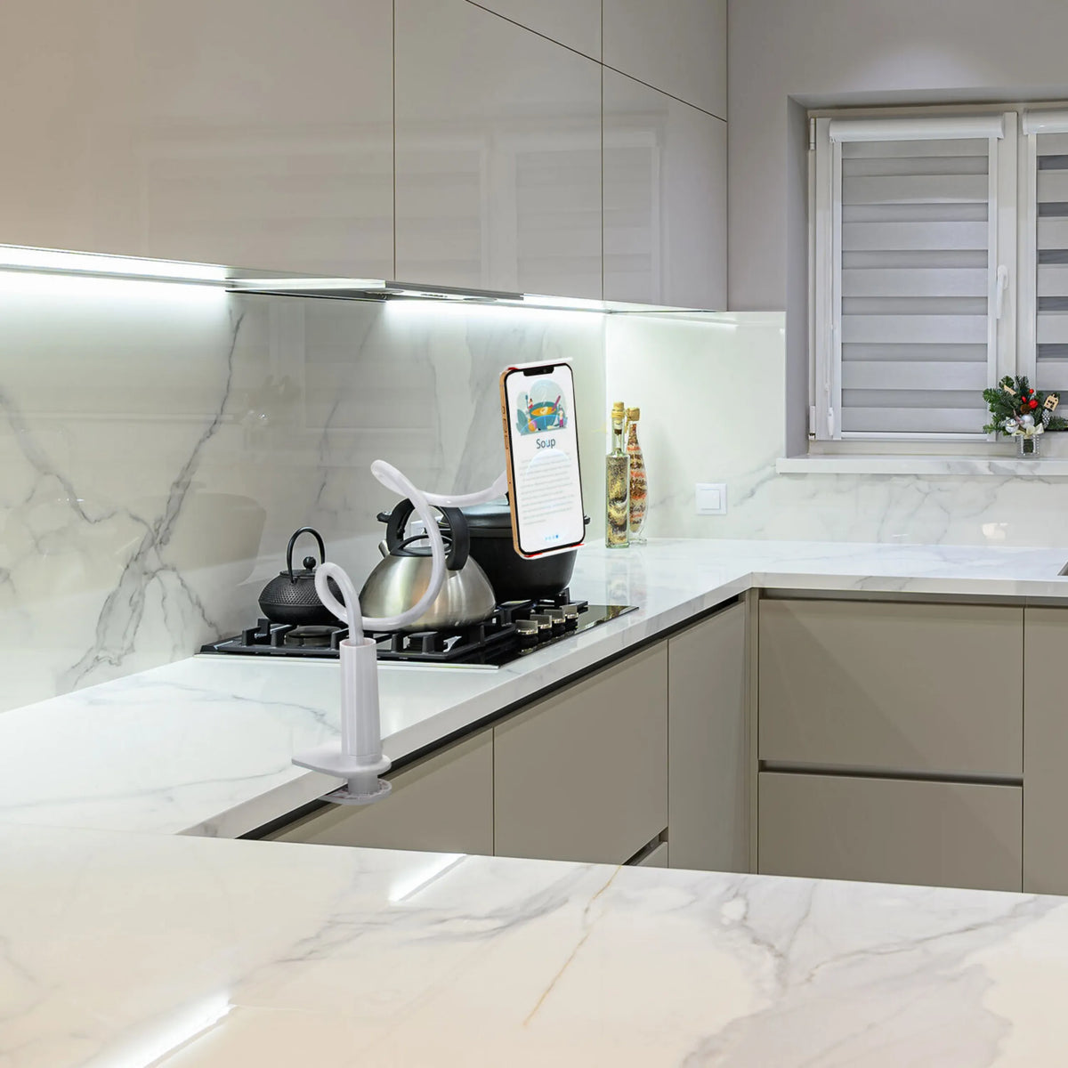 White Mobile phone & tablet holder FLEXMOBI I with flexible gooseneck arm on a kitchen unit by hjh OFFICE