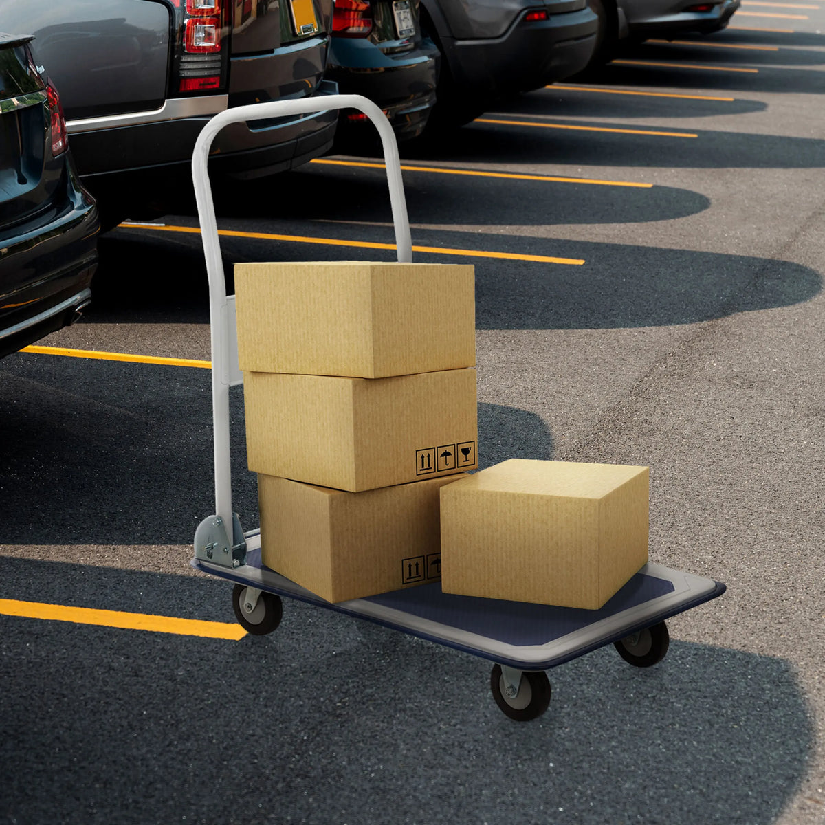 Blue and white platform trolley CARRY with three loaded cardboard boxes in a car park by hjh OFFICE