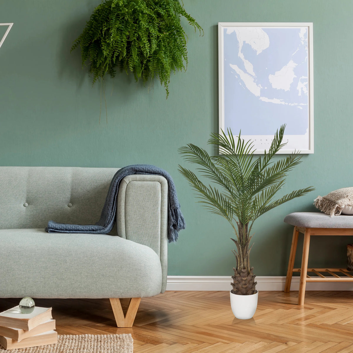 Green artificial plant DRACAENA in a white pot on a wooden floor by hjh OFFICE