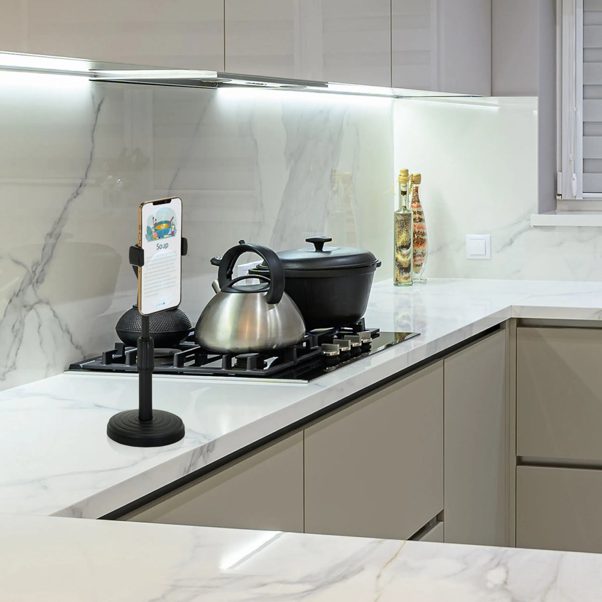 Black Mobile phone & tablet holder FLEXMOBI II on a white kitchen worktop by hjh OFFICE