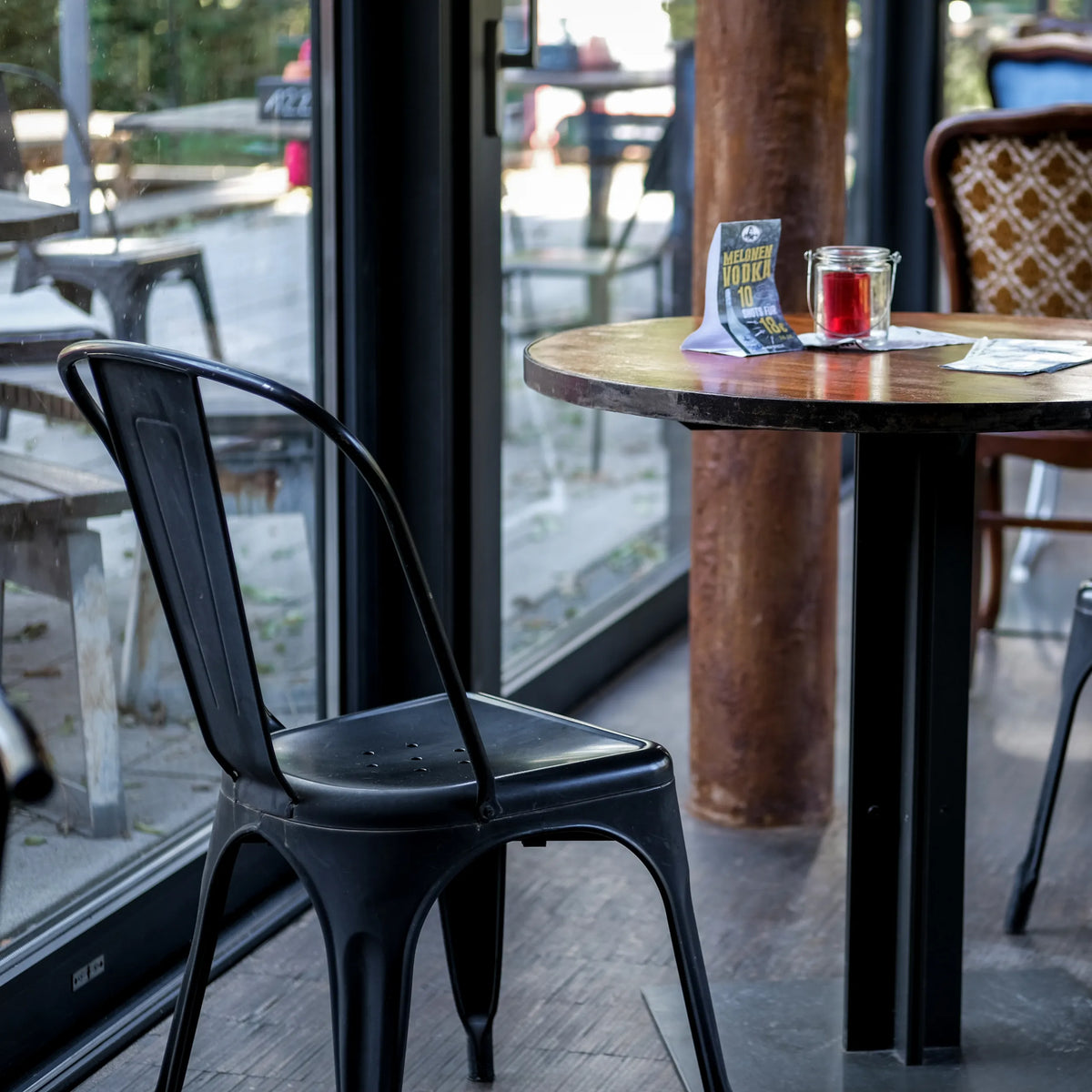 Black Bistro chair VANTAGGIO BRUSH with a curved backrest at a round table by hjh OFFICE