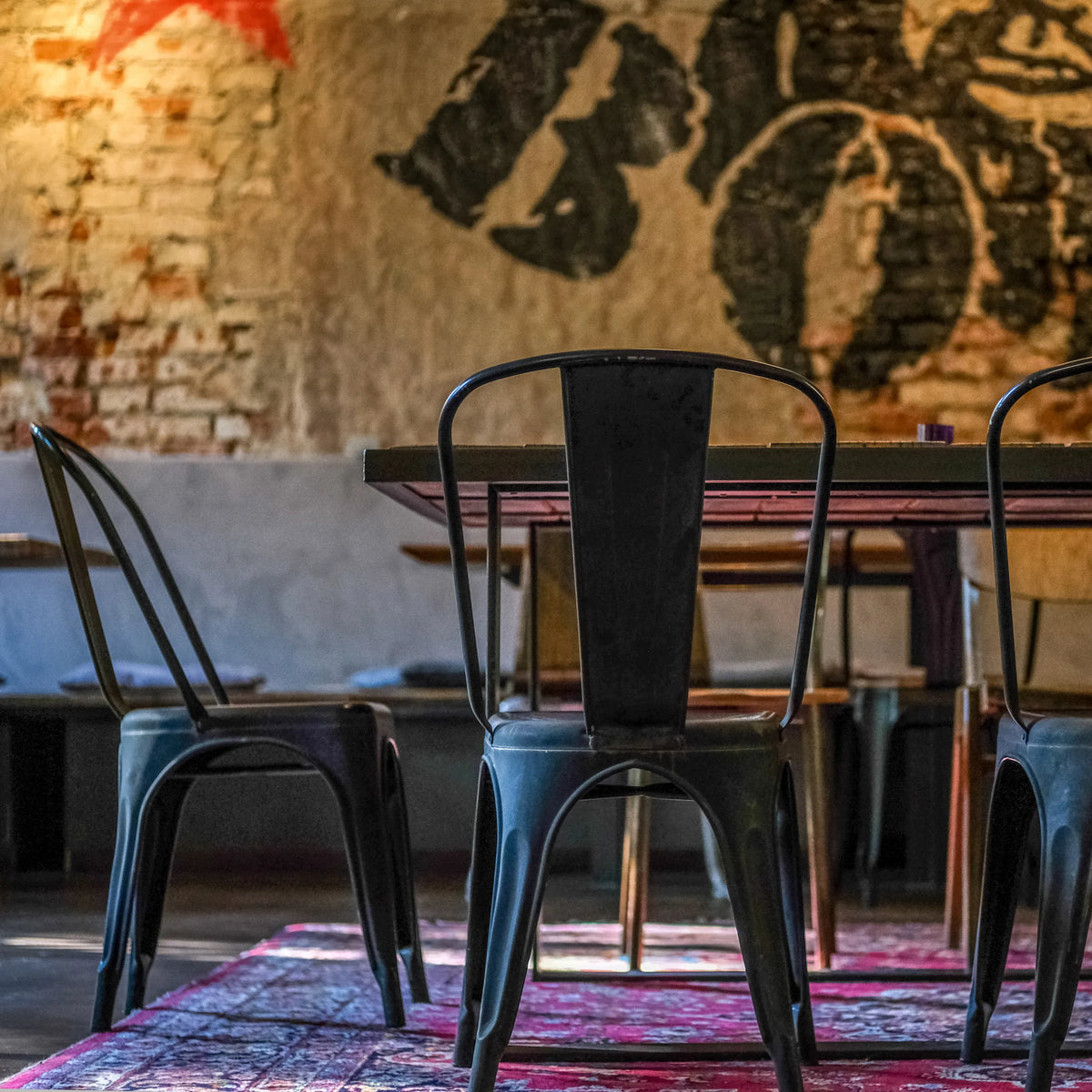 Rear view of a black metal VANTAGGIO BRUSH bistro chair at a table by hjh OFFICE