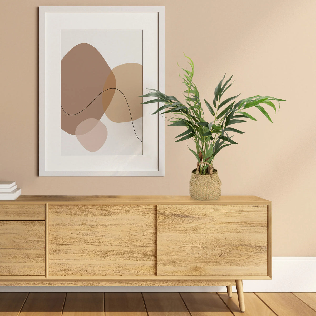 Green Artificial plant CHAMAEDOREA in a woven pot on a sideboard by hjh OFFICE