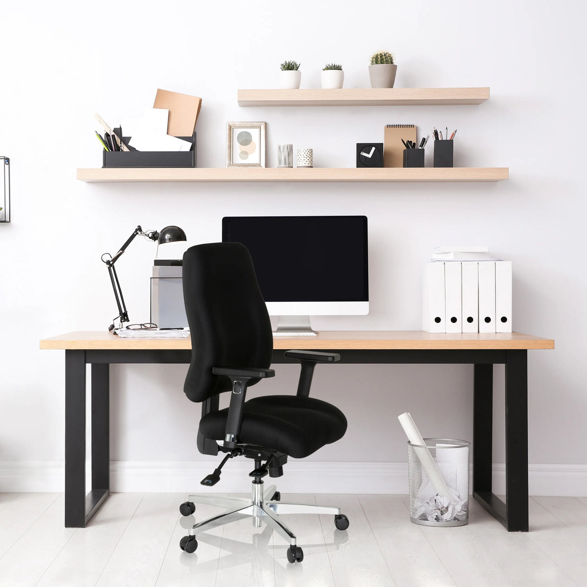 Black professional office chair ZENIT COMFORT at a desk in a bright study by hjh OFFICE