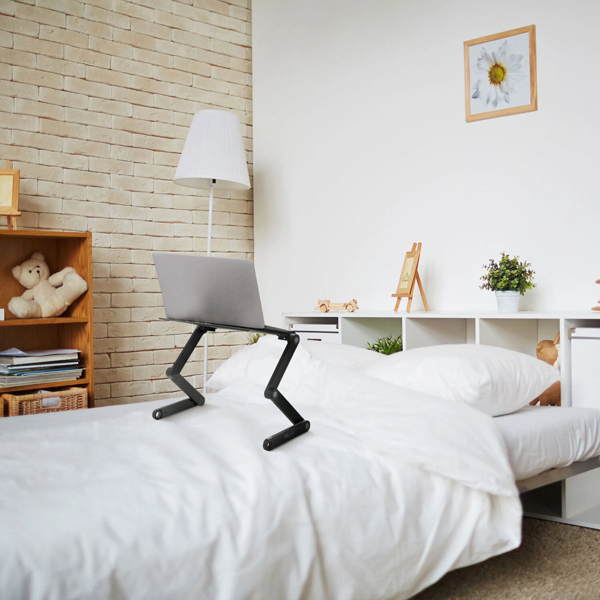 Black VM-SA II desk pad with a laptop on a bed in a bright room by hjh OFFICE
