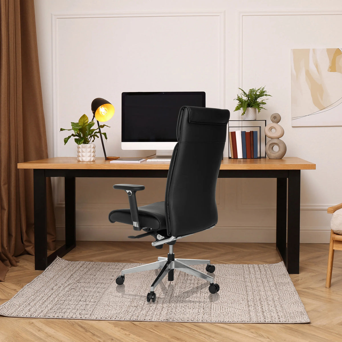 Black Professional Executive Chair CURYO with headrest and armrests at a desk in a home office by hjh OFFICE