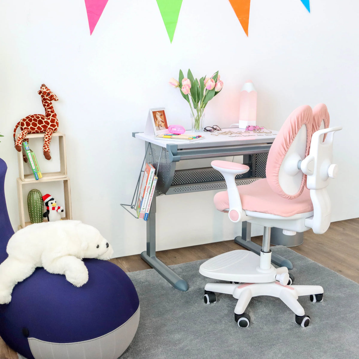 Pink children's chair KID WING with white frame and castors in front of a children's desk by hjh OFFICE
