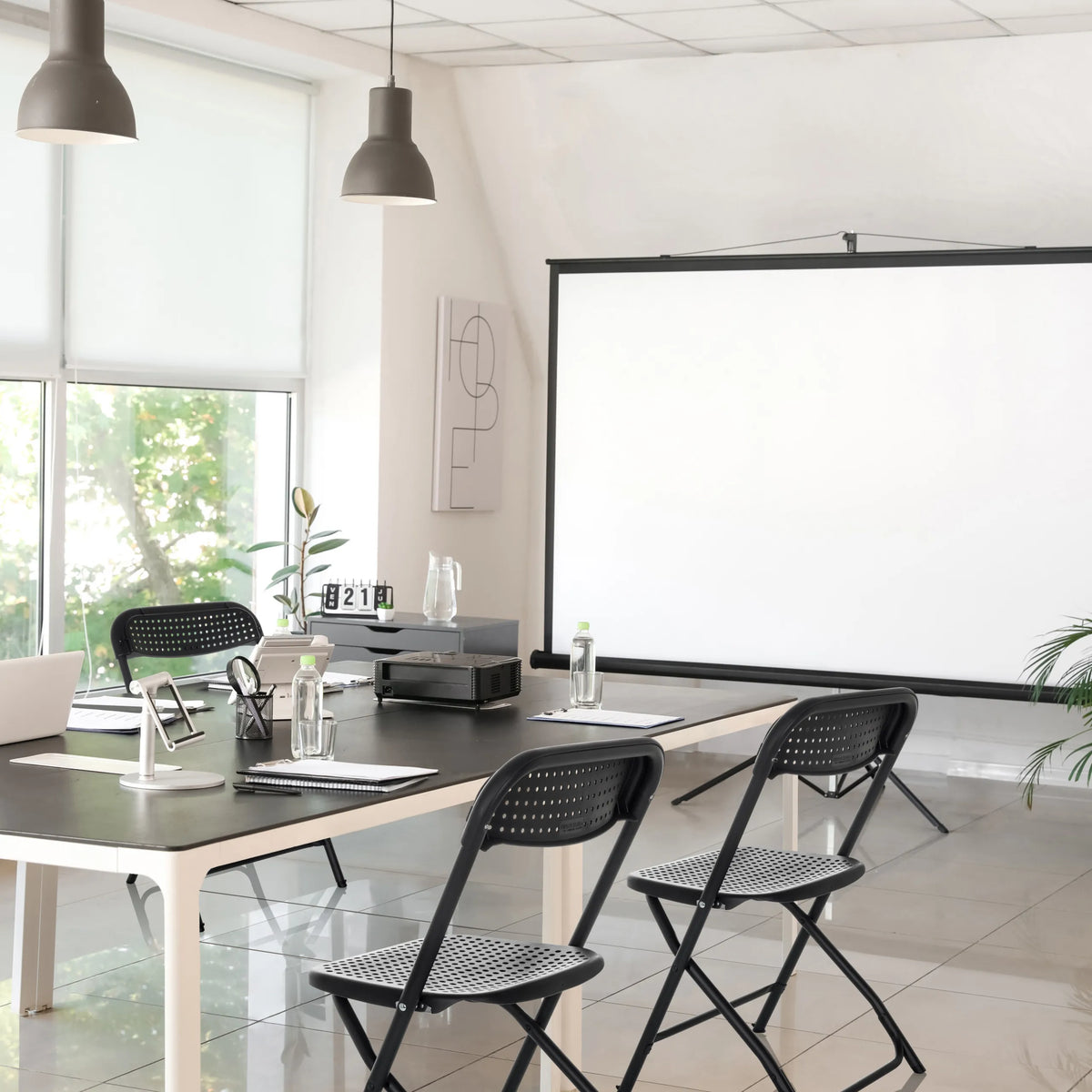 Two black Outdoor chairs TUDELA XXL PRO with perforated seats at a table by hjh OFFICE