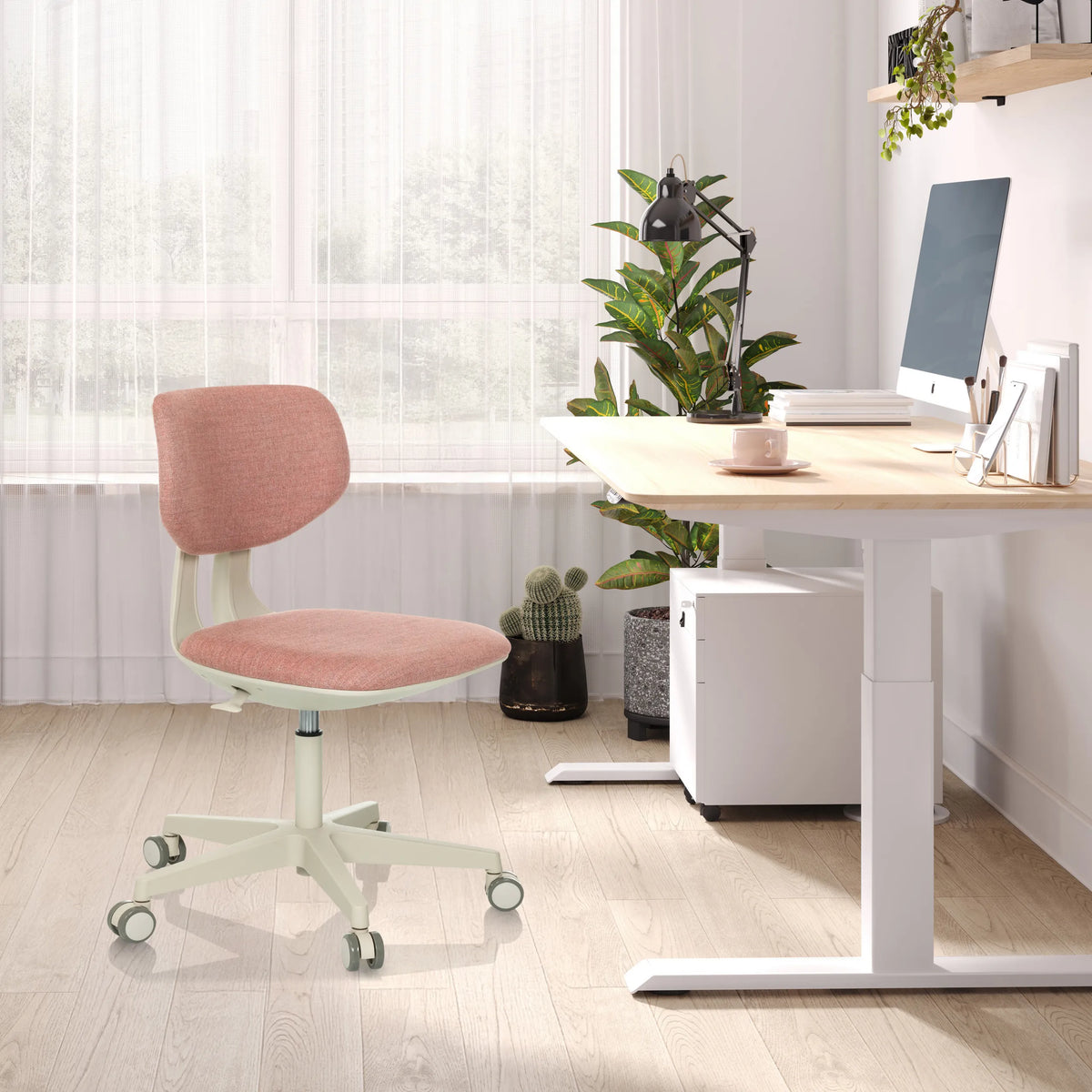 Pink children's swivel chair KID CLASSIC with white frame and castors at a light-coloured desk by hjh OFFICE