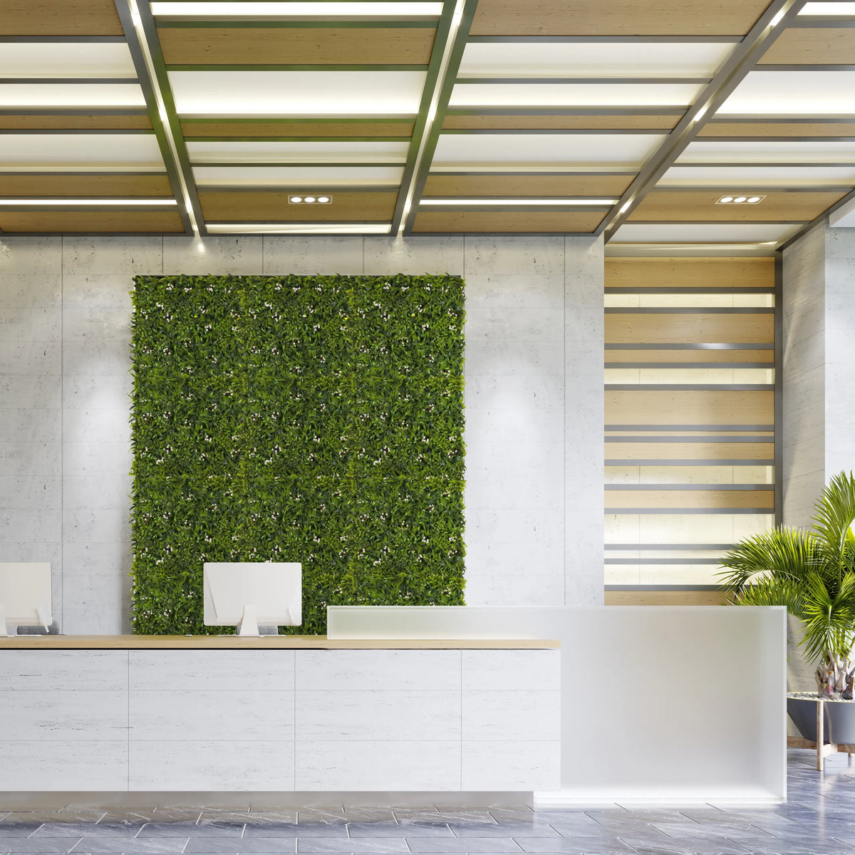 Green plant mat MORE GREEN I as vertical greenery on a light concrete wall in a reception area by hjh OFFICE