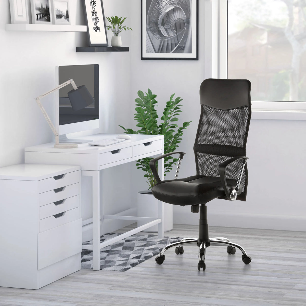 Home Office Executive Chair ARTON 20 in black with mesh backrest and armrests in front of a white desk by hjh OFFICE