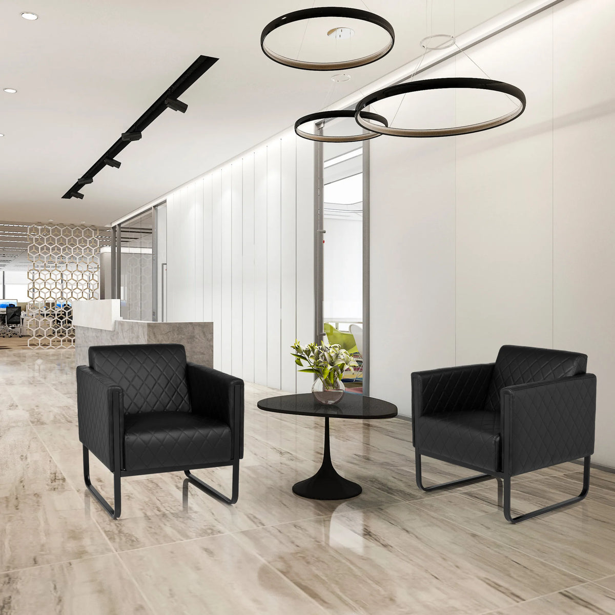 Two black ARUBA BLACK upholstered armchairs with quilting and sled bases next to a round side table by hjh OFFICE
