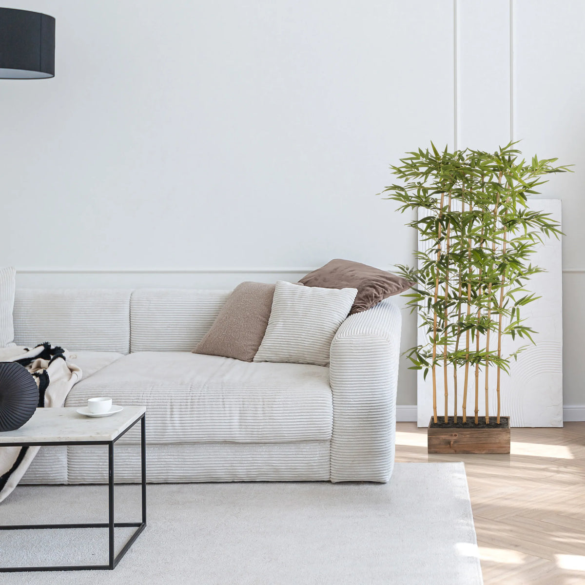 Green Artificial plant BAMBUS I in a wooden container next to a white sofa by hjh OFFICE