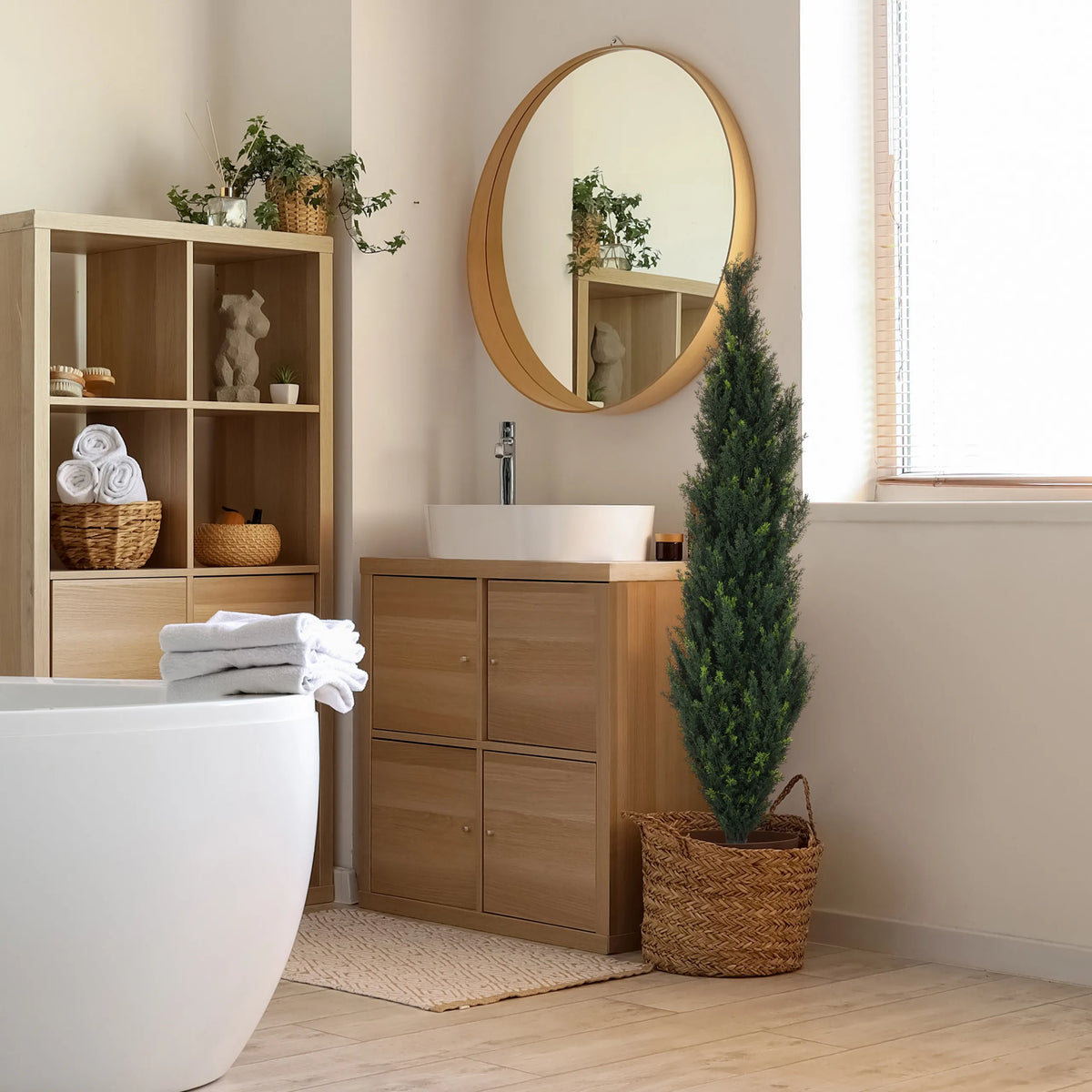 Green artificial plant CEDRUS in a woven basket next to a bathroom cabinet by hjh OFFICE