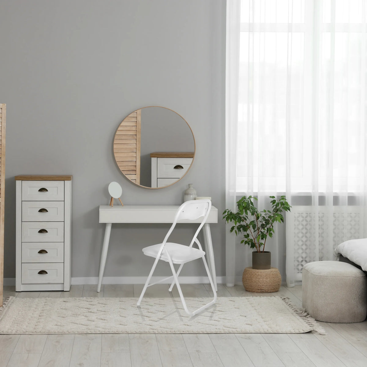 White TUDELA BASIC folding chair made of PVC in a bright room interior by hjh OFFICE