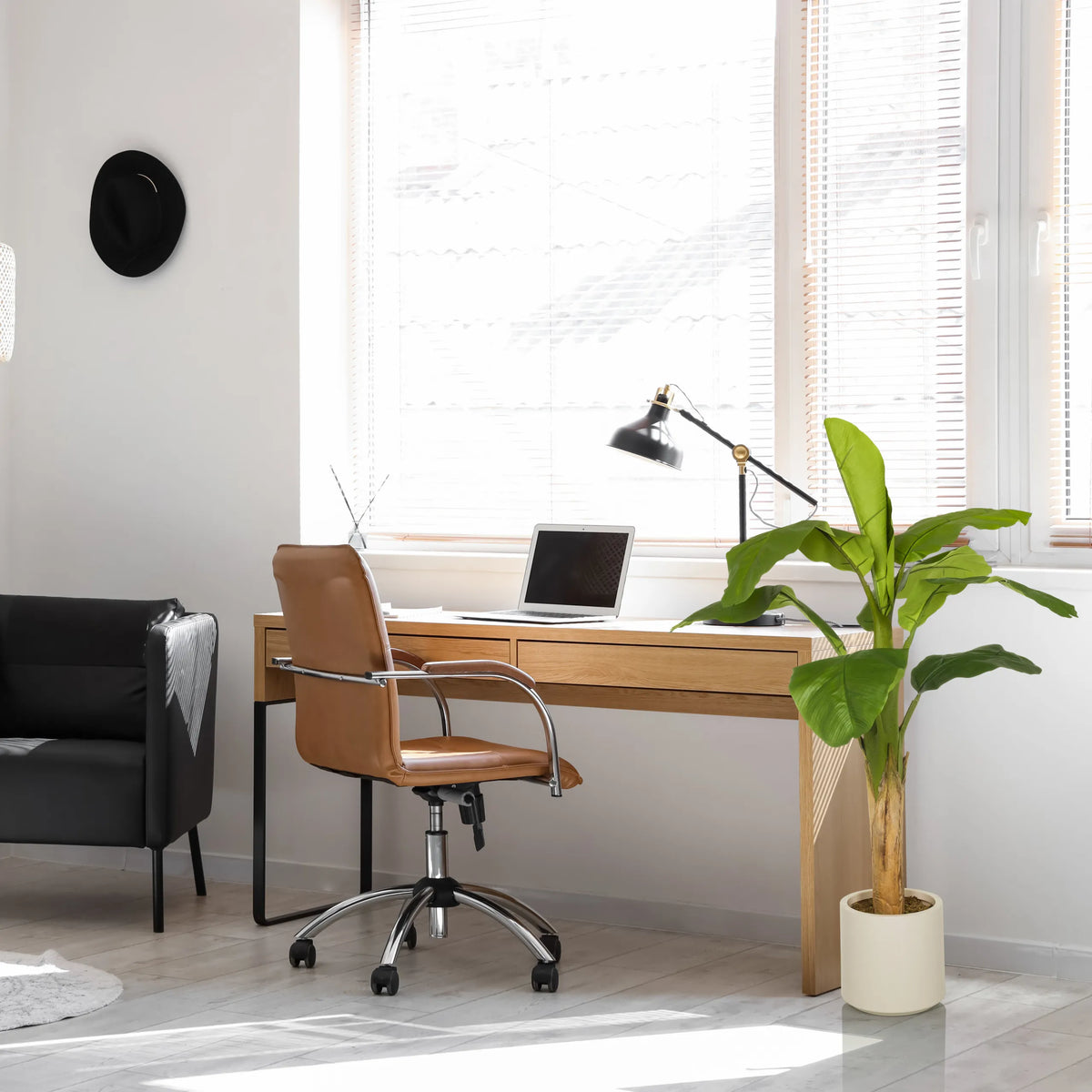 Green artificial plant BANANE I in a light-coloured pot next to a desk by hjh OFFICE