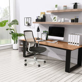 High End Office Chair FOUNTAINE PRO in black with mesh backrest in front of a desk by hjh OFFICE