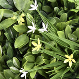 Green leaves with small white and yellow flowers of the Plant mat LEAFLUXE WALL 2 by hjh LIVING