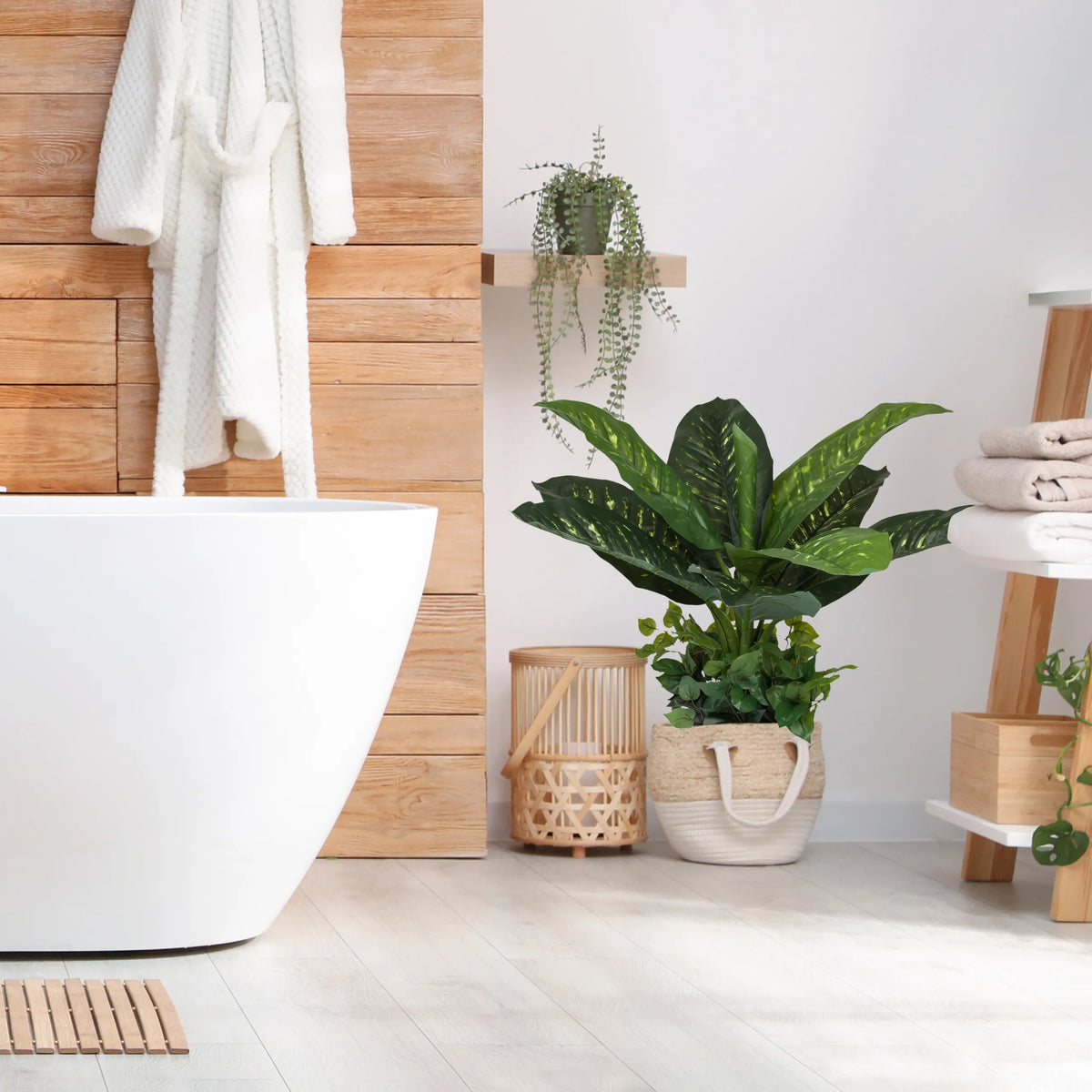 Green artificial plant DIEFFENBACHIA in a woven basket in the bathroom by hjh OFFICE