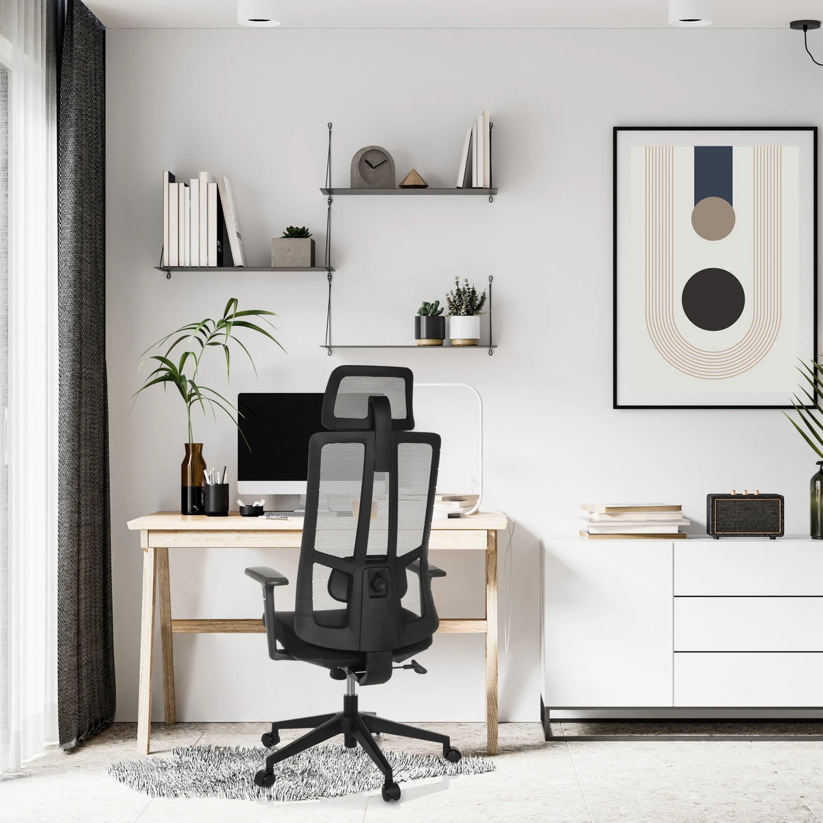 Black Professional Office Chair TRAMORE with mesh backrest and castors in a bright home office by hjh OFFICE