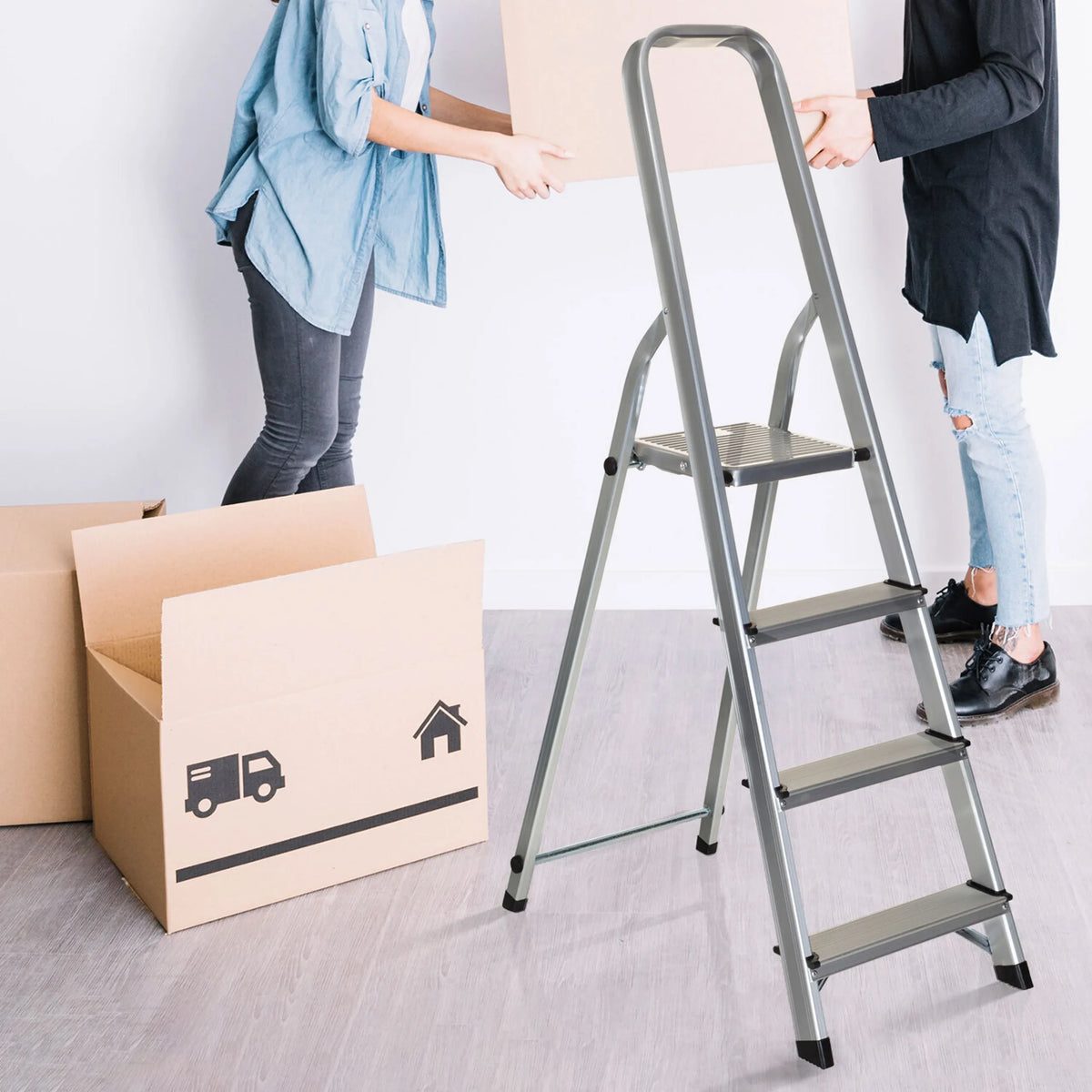 Four-step aluminium folding ladder SOLID II next to moving boxes by hjh OFFICE