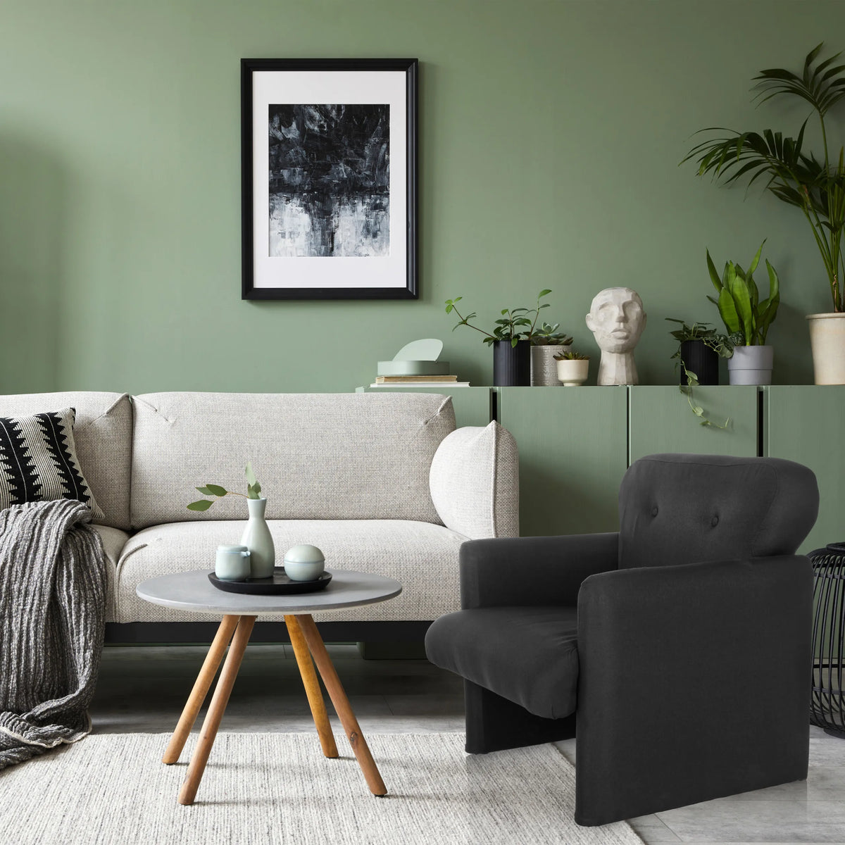 Black Lounge Chair CARIPITO with fabric upholstery in a living room setting by hjh LIVING