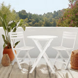 White folding table TRAVANO T with two matching folding chairs on a terrace by hjh LIVING