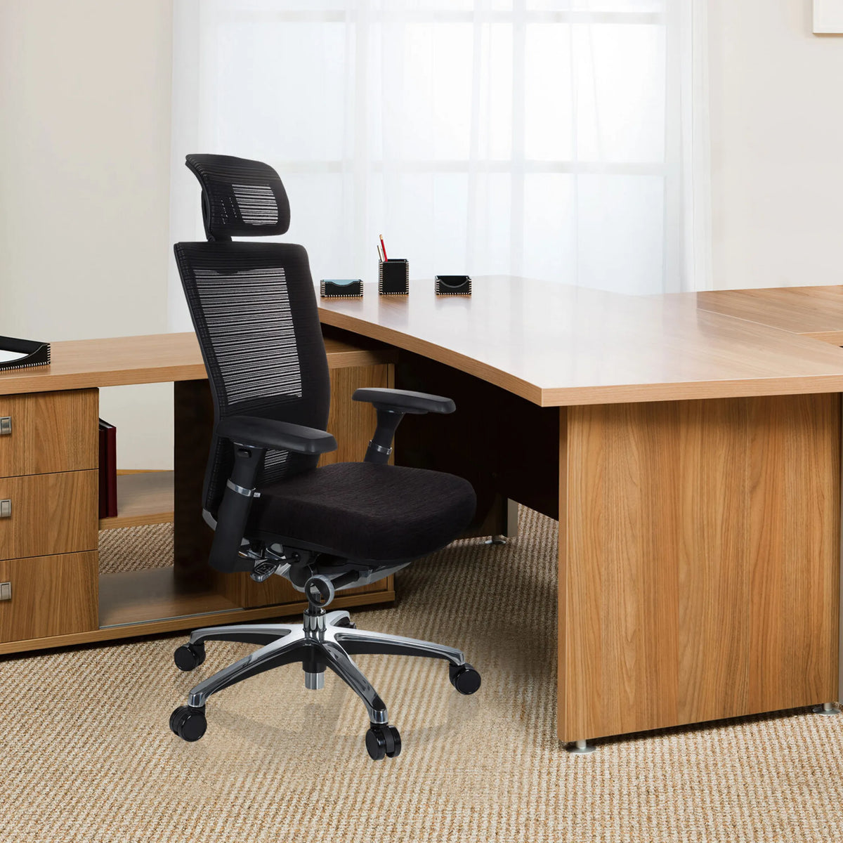 Black High End Office Chair NOVA PRO I with mesh back and headrest in front of a desk by hjh OFFICE
