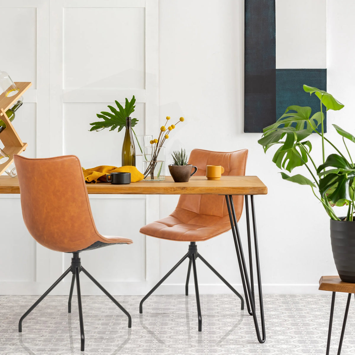 Two brown upholstered chairs TARVISO PU with black metal legs at a wooden table by hjh OFFICE