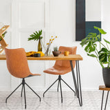 Two brown upholstered chairs TARVISO PU with black metal legs at a wooden table by hjh OFFICE