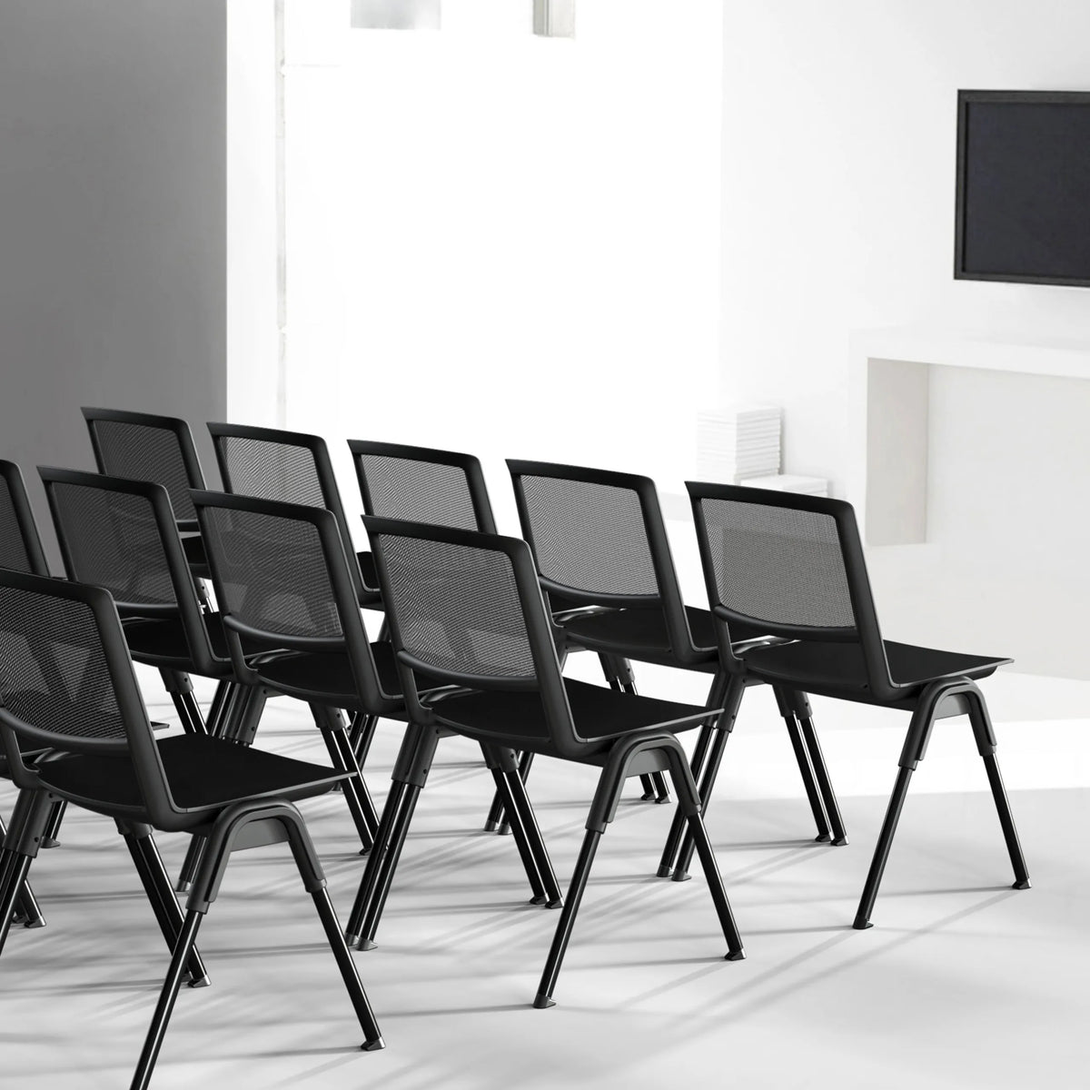 Several black MEET WA guest chairs with mesh backrests in a row by hjh OFFICE
