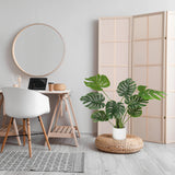 Green artificial plant MONSTERA I in a white pot on a woven pedestal by hjh OFFICE