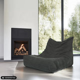 Grey corduroy Sitzolo lounge chair in front of a fireplace by hjh LIVING (AI-generated image)