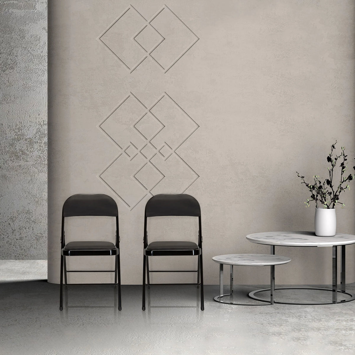 Two black TUDELA folding chairs with faux leather upholstery in front of a beige wall by hjh OFFICE