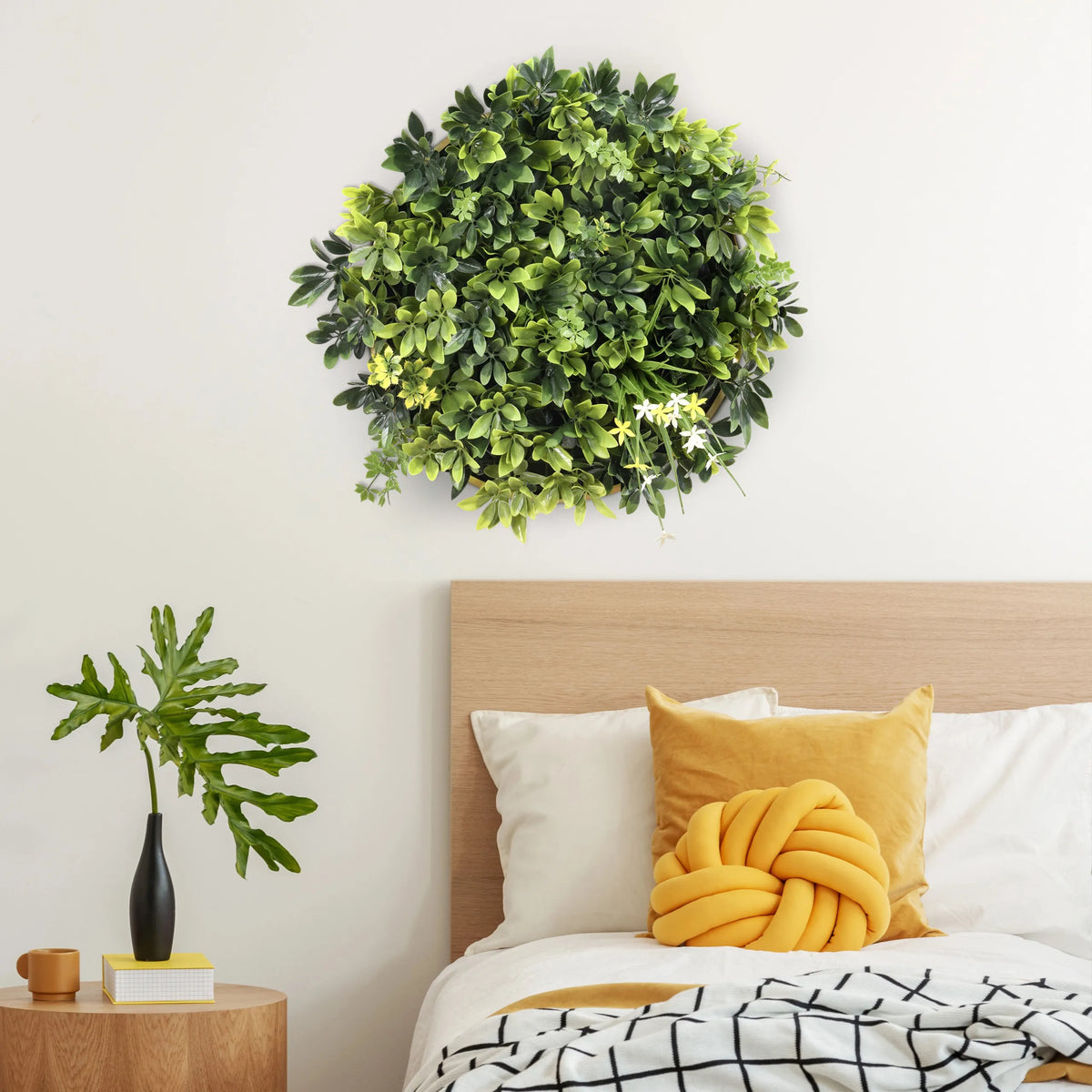 Green plant mat LEAFLUXE WALL 2 as a round wall decoration above a bed by hjh LIVING