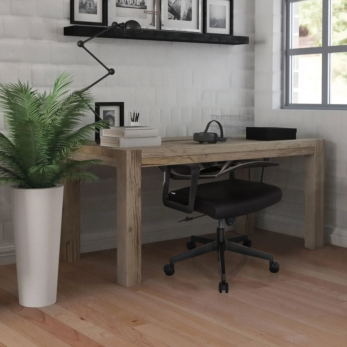 Black Home Office Chair ENCO at a wooden table in a bright room by hjh OFFICE