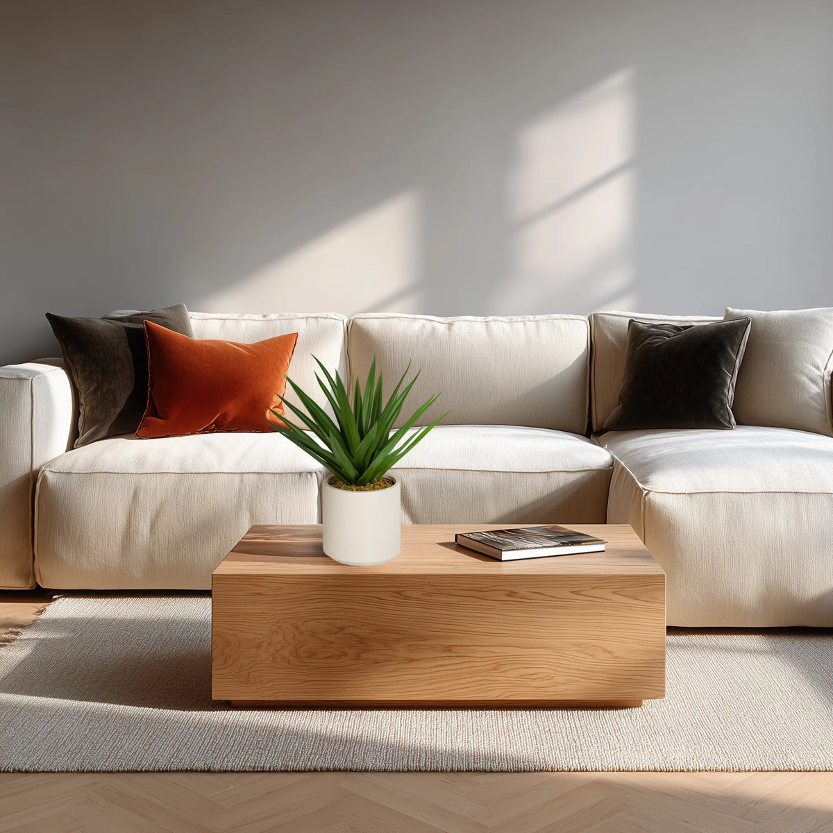 Artificial plant Agave in green with a white pot on a wooden table in front of a light-coloured sofa by hjh OFFICE