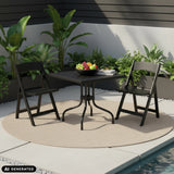 Black TRAVANO T1 folding table with two matching folding chairs outdoors by hjh LIVING (AI-generated image)