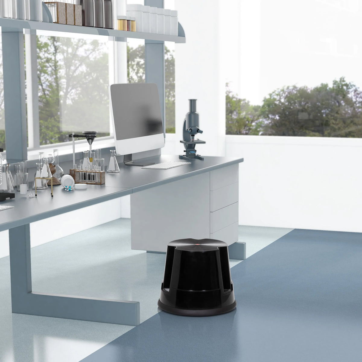 Black step stool TIO-S in front of a laboratory table in a bright room by hjh OFFICE