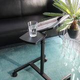 Black surface of the VM-SL standing desk with a glass and a magazine on a carpet by hjh OFFICE