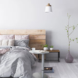 White Standing desk STAND III with round top next to a bed by hjh OFFICE