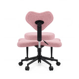 Rear view of the pink Asanasit meditation chair with a heart-shaped backrest and a black cross base by hjh LIVING