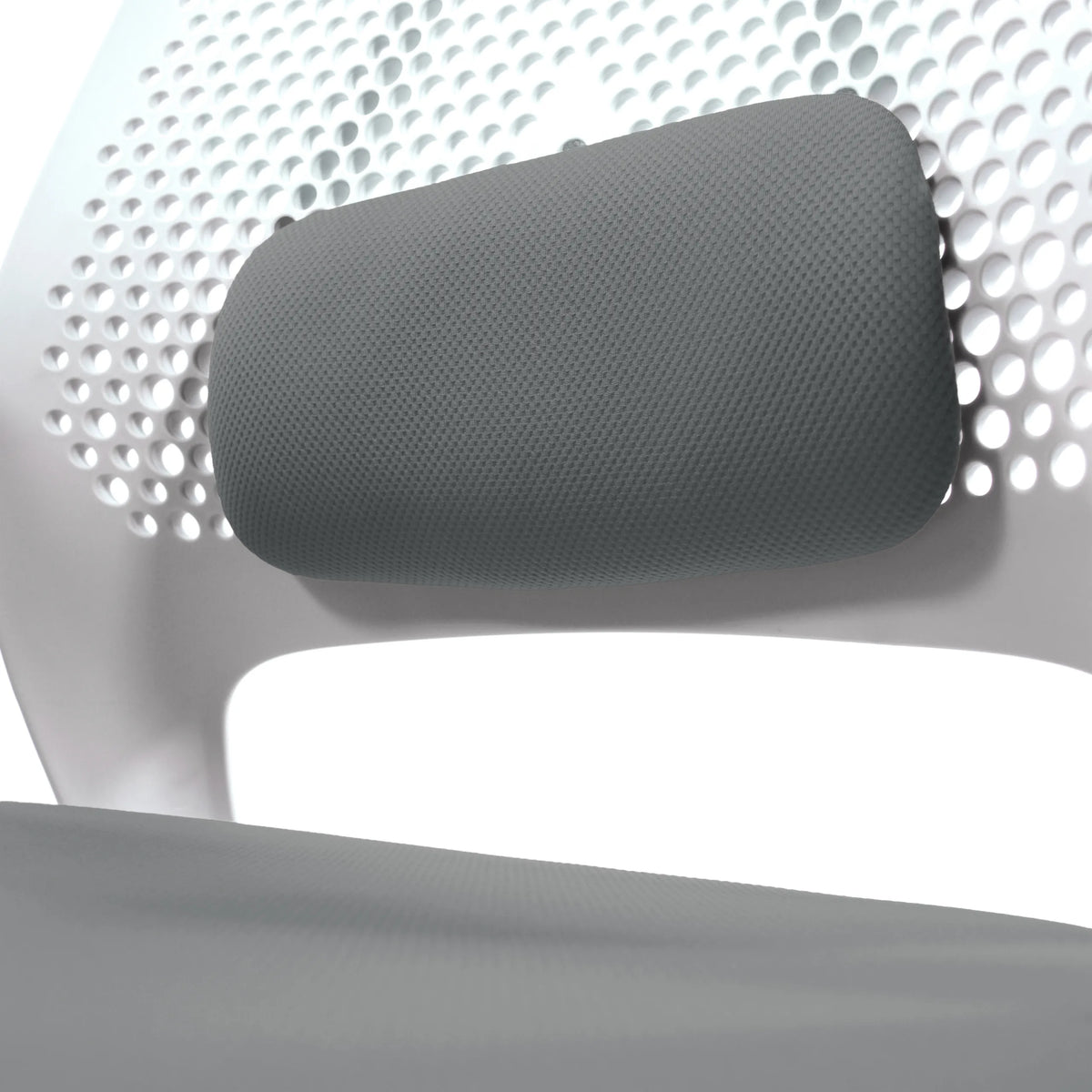 Grey headrest of the PARFERIO W home office chair in front of a perforated white backrest by hjh OFFICE