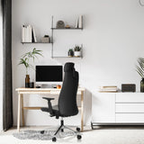 Black Professional Executive Chair YUCANO I at a desk in a bright room by hjh OFFICE