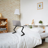 Black VM-SA II desk pad with a laptop on a bed in a bright room by hjh OFFICE